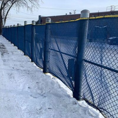 Blue Scafnet on a chain link fence.