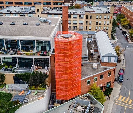 Orange Scafnet installed on a scaffold tower.